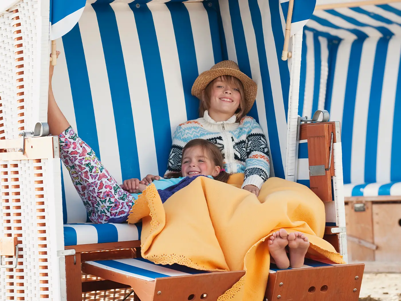 Zwei Kinder, die im Strandkorb liegen